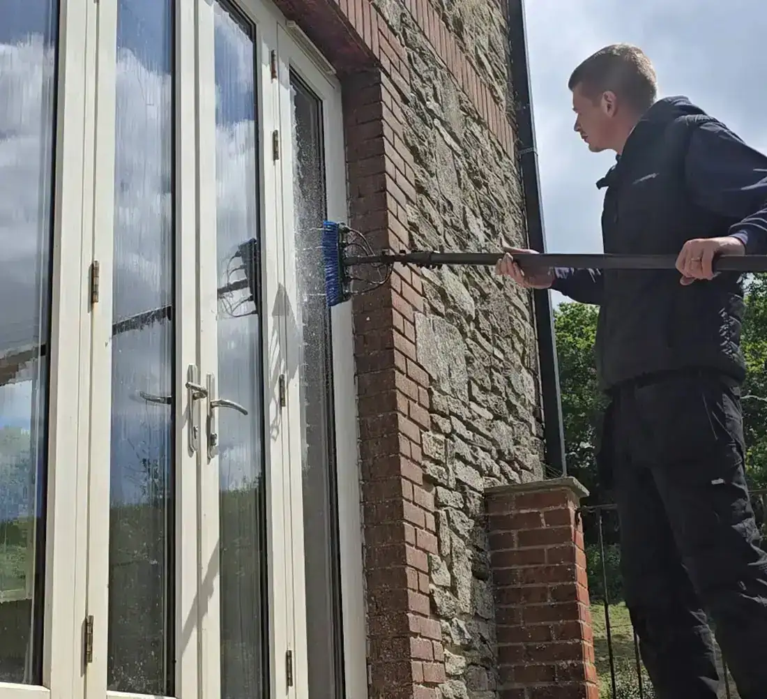 Pure water-fed pole system being used to clean upstairs windows